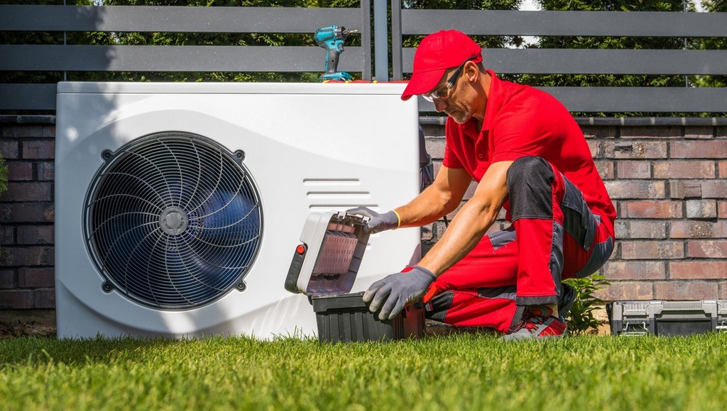 HVAC tech working on outdoor air conditioning unit