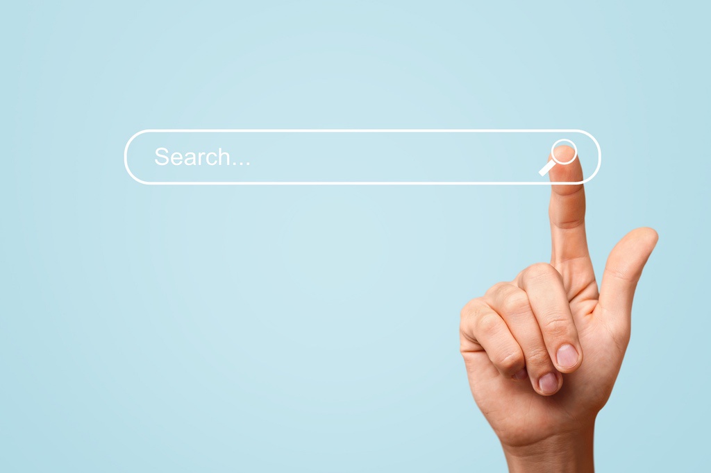 Rendering of human hand tapping search bar to symbolize user intent