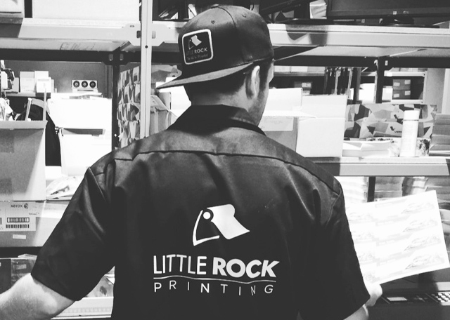 Little Rock Printing employee in warehouse wearing branded clothing